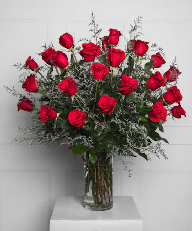 Variations of a medium stem red roses in a glass vase.