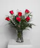 Variations of a medium stem red roses in a glass vase.