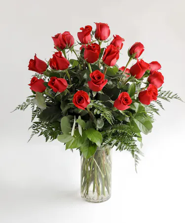 Variations of a dozen red roses in a glass vase.
