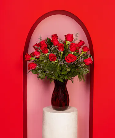 Variations of a medium stem red roses in a glass vase.