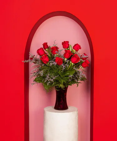 Variations of a medium stem red roses in a glass vase.
