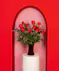 Variations of a medium stem red roses in a glass vase.