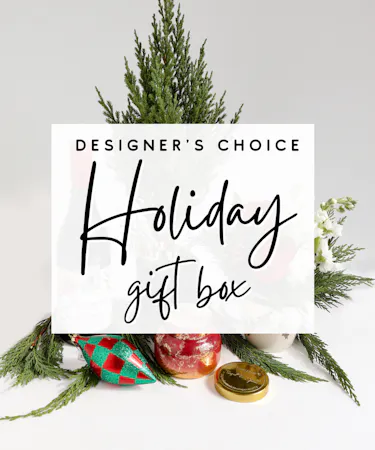 A curated box full of fresh holiday gifts including ornaments, a holiday plant, holiday-inspired candles, and other floral and plant products filled to value.