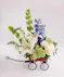 A blue and ivory arrangement designed in a mini keepsake red wagon. 
