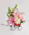 A pinkand ivory arrangement designed in a mini keepsake red wagon. 