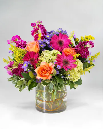 old and fearless, this arrangement features vibrant colors like hot pink, commanding attention with every petal. 