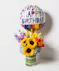 colorful bouquet with hydrangea, sunflowers, roses, asiatic lilies, and lisianthus in a tall cylinder glass leaf-lined vase, and comes with a fun birthday mylar balloon