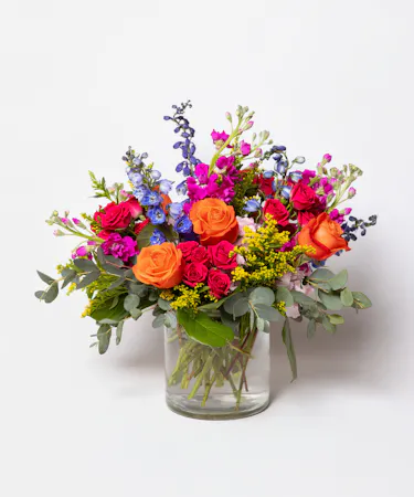 Born to be Wild is a vibrant fusion of hot pink and orange blooms designed to ignite joy and celebrate birthdays with flair. 