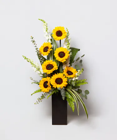 We design a gorgeous bouquet of locally-grown sunflowers and fresh snapdragons in a tall glass vase, and pair it with the wine of your choosing.