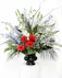 A floral arrangement of patriotic red, white, and blue flowers sends a silent yet poignant statement about hope, freedom, and the strength to endure.