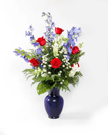 A striking display of red, white, and blue patriotic petals that will deliver your condolences to the bereaved.