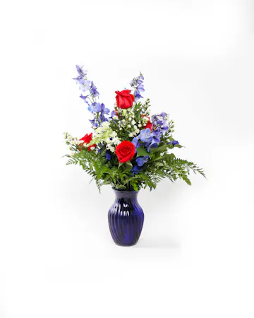 A striking display of red, white, and blue patriotic petals that will deliver your condolences to the bereaved.
