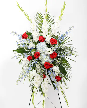 Incorporating colors of the American flag, this arrangement is sure to honor the brave soldier who fought for freedom and those who have a deep affection for our country.