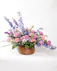 This basket of pastel flowers celebrates vivid memories of loved ones and expresses heartfelt sympathy to friends and family.