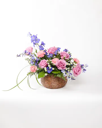 This basket of pastel flowers celebrates vivid memories of loved ones and expresses heartfelt sympathy to friends and family.