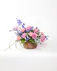 This basket of pastel flowers celebrates vivid memories of loved ones and expresses heartfelt sympathy to friends and family.