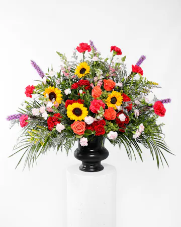 A stylish tribute of brilliant flowers ideal for the funeral home, service, or home. 
