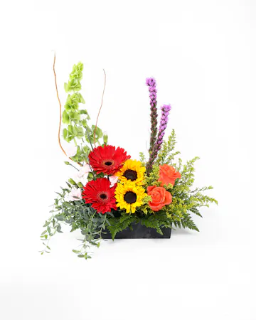 Reminisce on the beautiful memories you have with a loved one with this arrangement of colorful blooms. Have it shown during the funeral service or sent to the family's home.