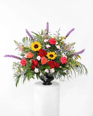 A stylish tribute of brilliant flowers ideal for the funeral home, service, or home. 