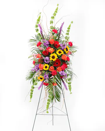 A showcase of colorful blooms in the shape of a cross that can be displayed in front of the service.
