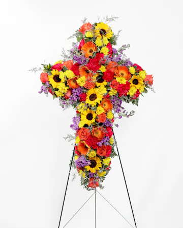 A showcase of colorful blooms in the shape of a cross that can be displayed in front of the service.