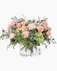 Filled with roses and carnations, This garden-styled arrangement blends the soft hues of peach-colored blooms with the lush greenery of a flourishing garden.