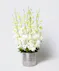 This arrangement includes stunning dendrobium orchids in a vase with exotic greenery.