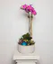 Lavender & Jewels features a rich palette of purple blooms, exuding grace and beauty, presented in a chic purple vase.