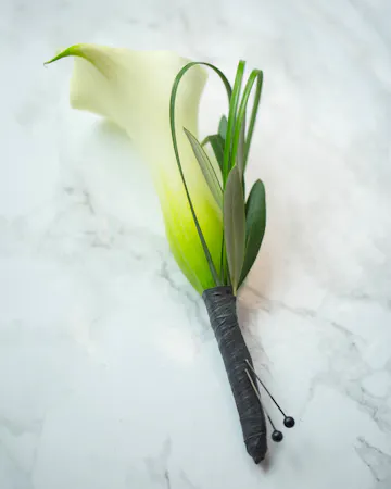 Perfect for Prom or Homecoming! This traditional boutonniere of italian ruscus, and an elegant white rose is the perfect accessory to your special day.