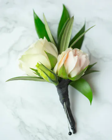 Perfect for Prom or Homecoming! This traditional boutonniere of italian ruscus, and an elegant white rose is the perfect accessory to your special day.