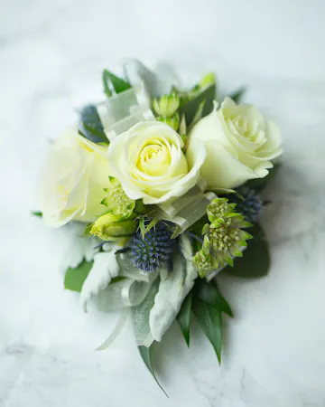 Perfect for Prom or Homecoming! This traditional boutonniere of italian ruscus, and an elegant white rose is the perfect accessory to your special day.