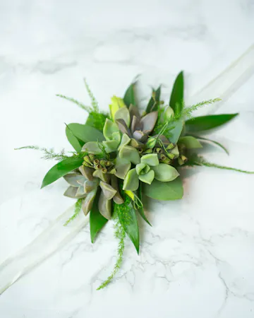 Perfect for Prom or Homecoming! This traditional boutonniere of italian ruscus, and an elegant white rose is the perfect accessory to your special day.