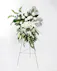 This display of white blooms is artfully arranged amongst lush greenery creating an outstanding way to honor the life of your loved one. 