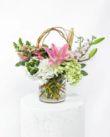 This arrangement is a delicate display of pink flowers that beautifully deliver a sincere expression of love and sympathy. 
