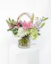This arrangement is a delicate display of pink flowers that beautifully deliver a sincere expression of love and sympathy. 