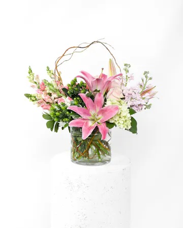 This arrangement is a delicate display of pink flowers that beautifully deliver a sincere expression of love and sympathy. 