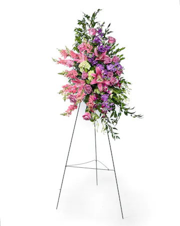 Pink and Purple blooms come together to create a beautiful standing spray for the service. 