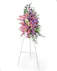 Pink and Purple blooms come together to create a beautiful standing spray for the service. 