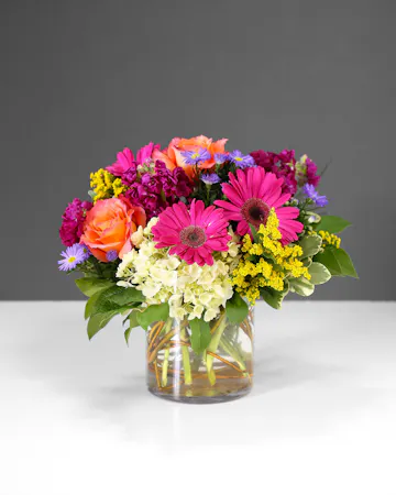 old and fearless, this arrangement features vibrant colors like hot pink, commanding attention with every petal. 