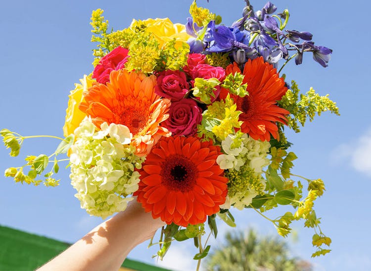 A lovely orange, purple and yellow floral arrangement